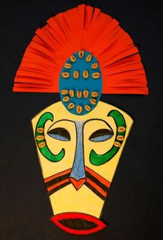 a colorful mask is hanging on the wall