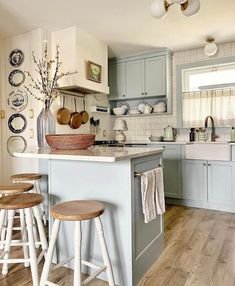 a kitchen with blue cabinets and wooden stools