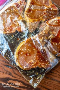 sliced up oranges sitting on top of a piece of tin foil covered in brown sugar