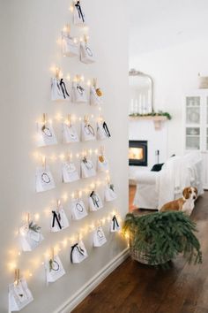 a christmas tree made out of bags and lights on the wall in a living room