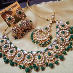 This Kundan choker set epitomizes the traditional charm of Indian jewelry with a stunning gold-plated finish. Adorned with intricate Kundan work, this set boasts a classic yet opulent design, embodying the essence of Indian cultural heritage. The set includes a choker necklace and matching earrings, along with a Mang Teeka (forehead ornament), adding an extra touch of grace and elegance. The inclusion of mirrors in the design infuses a touch of Bollywood glamour, giving it a modern and chic edge. Ideal for special occasions and celebrations, this set effortlessly channels the richness of Indian traditions while embracing the allure of Bollywood fashion. The ornate craftsmanship and the fusion of classic Kundan work with mirror detailing make this set a statement piece that exudes sophistic Diwali Chandbali Kundan Necklace With Motifs, Green Bollywood Necklace For Navratri, Bollywood Green Necklace For Navratri, Bollywood Style Green Necklace For Navratri, Bollywood Style Gold Plated Jewelry Sets For Festive, Bollywood Style Jewelry For Eid With Motifs, Kundan Chandbali Necklace With Motifs For Celebration, Gold Chandbali Bridal Necklace With Motifs, Celebration Kundan Chandbali Necklace With Motifs