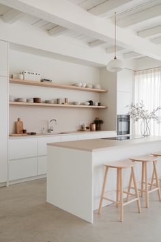 Japandi-Style White Kitchen Cabinets with Beige Countertops White And Sand Kitchen, Kitchen Beige Countertops, White Oak Kitchen Cabinets Modern, Beige Countertops, White Kitchen Cabinets Ideas, Stair Landing Decor, Japandi Style Kitchen, Tranquil Aesthetic, White Contemporary Kitchen