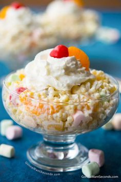 a bowl filled with cereal and marshmallows on top of a blue table