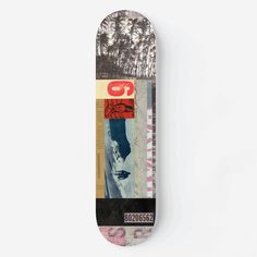 a skateboard that is laying on top of a white surface, with the bottom part of it's board covered in images