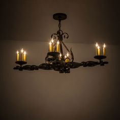 a chandelier with lit candles hanging from it