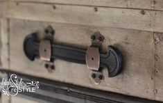 an old trunk with some metal handles on it's sides and two black knobs