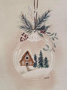 a watercolor painting of a christmas ornament with a house in the snow