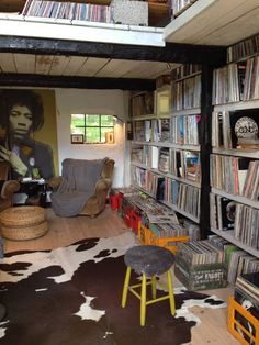 a living room filled with lots of furniture and bookshelves covered in vinyl records