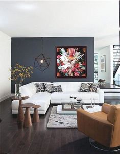 a living room filled with furniture and a painting hanging on the wall over a fire place