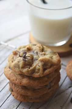 a stack of cookies next to a glass of milk