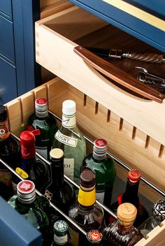 an open drawer with many bottles in it