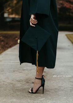 a woman in black graduation gown and high heels