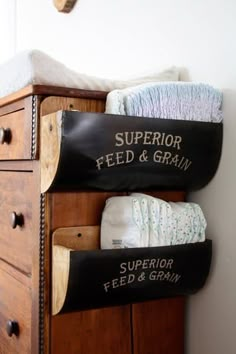 there are two black bags on top of the drawers in this room and one is filled with diapers