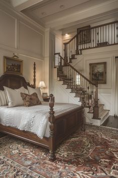 a large bed sitting under a stair case in a bedroom