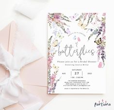 the butterfly bridal shower is shown on top of a pink envelope and white ribbon