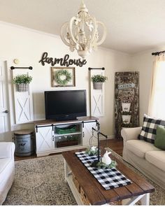 a living room filled with furniture and a flat screen tv on top of a wooden table