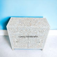 a white wooden box with the words luxury handicrafts written in black on it