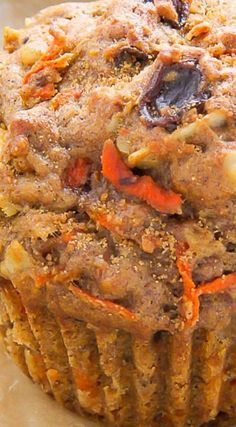 a close up of a muffin with carrots and nuts