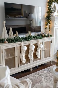 a living room with christmas stockings hanging from the wall