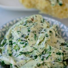 a bowl filled with cheese and spinach on top of a table