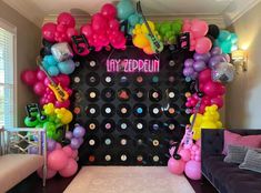 a party room with balloons and music instruments on the wall