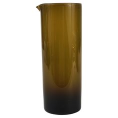 a brown and black vase sitting on top of a table