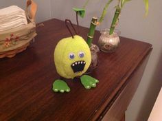 an odd looking stuffed animal sitting on top of a wooden table