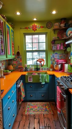 the kitchen is brightly colored and has many dishes on the counter top, including an oven