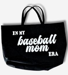 This IN MY BASEBALL MOM ERA Tote is the perfect accessory for any casual occasion! Made from 100% cotton canvas, it's both lightweight and durable, making it an ideal choice for everyday use. The tote features a graphic pattern that's both bold and eye-catching, adding a touch of athletic flair to your look. The double handle strap type is comfortable to carry by hand or over your shoulder while the extra large size provides ample room for all your essentials. Machine washable care instructions Casual Canvas Bag For Everyday Use And Mother's Day, Casual Cotton Canvas Bag For Mother's Day, Black Cotton Canvas Bag For Weekend, Casual Black Canvas Bag With Letter Print, Black Casual Bag For Sports Events, Casual Black Bag For Sports Events, Cotton Canvas Bag With Letter Print For Weekend, Mom Tote Bag, Mom Era