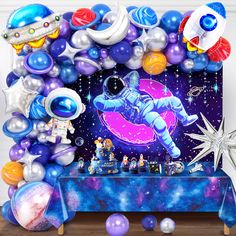 an astronaut themed birthday party with balloons and decorations