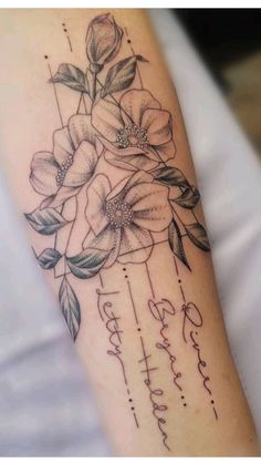 a woman's arm with flowers on it and the words happy birthday written in cursive writing