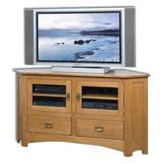 an entertainment center with a flat screen tv on it's side and two drawers