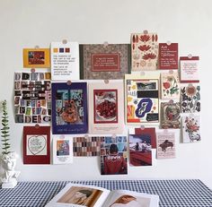 an open book sitting on top of a blue and white checkered tablecloth covered table