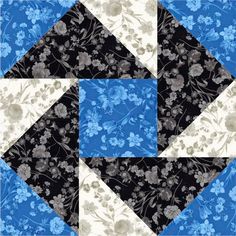 a blue and black quilt with white flowers on the center, in front of a flowered background