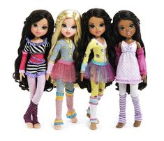 four dolls standing next to each other in front of a white background and one has long black hair