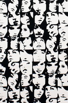 a black and white photo of many faces