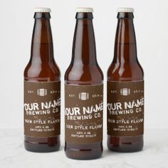 three brown beer bottles sitting next to each other