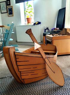 a cardboard boat sitting on top of a rug