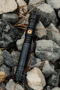 a flashlight is laying on some rocks