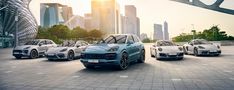 five porsche cayens parked in front of a cityscape