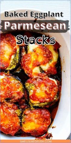 baked eggplant parmesan stacks in a white dish with text overlay