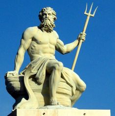 a statue of a man holding a pitchfork on top of a building