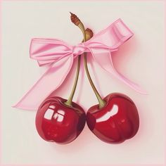 two cherries tied to a pink ribbon with a bow on it's end