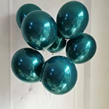 a bunch of green balloons floating on top of each other in front of a door