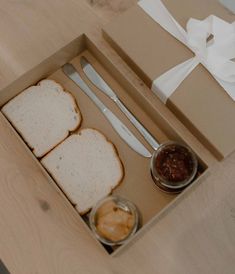 two slices of bread in a box with silverware