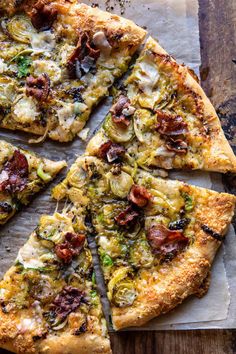 a pizza cut into eight pieces on top of a wooden table with one slice missing