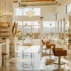 a salon with lots of chairs and bottles on the wall, near large windows that look out onto mountains