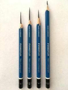 three blue pencils sitting next to each other