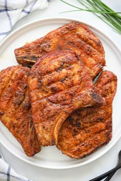 grilled pork chops on a white plate