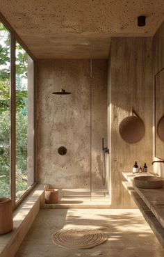 a bathroom with two sinks and a large window in the corner, next to a walk - in shower